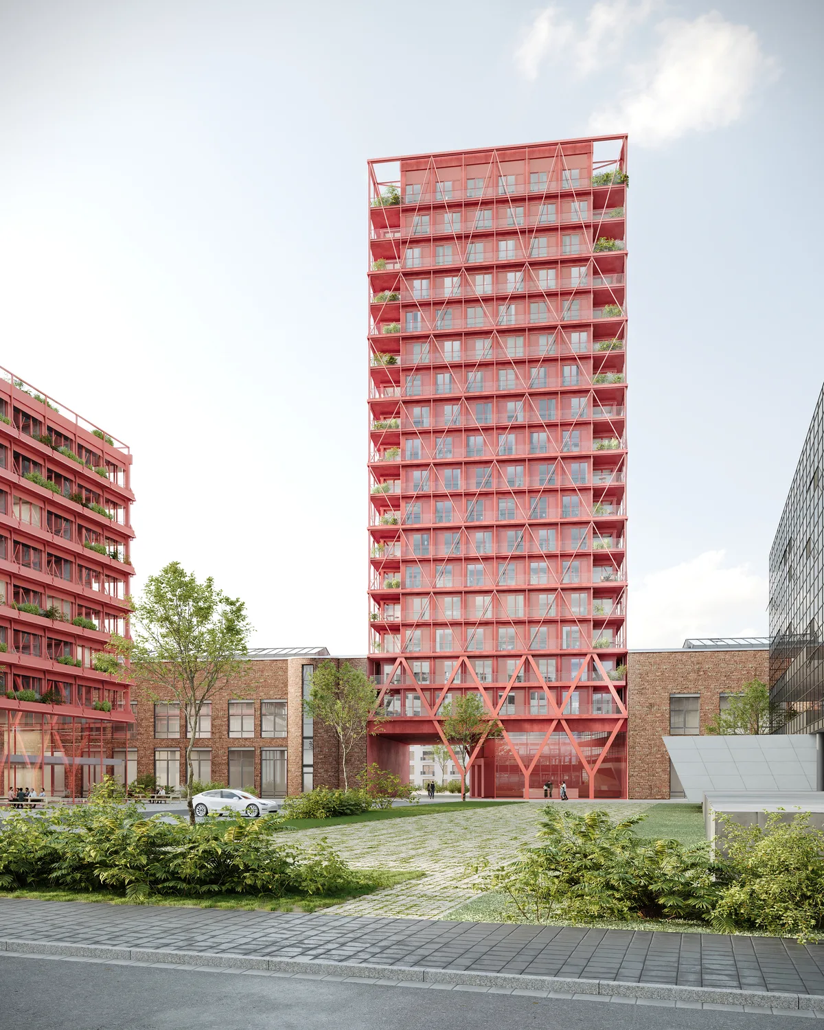 Modernes, hohes Wohn- oder Bürogebäude mit auffälliger roter Fassade und Gitterstruktur, das in einem urbanen Umfeld platziert ist. Links sieht man ein weiteres, ebenfalls rotes, etwas niedrigeres Gebäude. Im Vordergrund gibt es grüne Pflanzen, eine kleine Auffahrt, einige Bäume und einen weißen PKW.